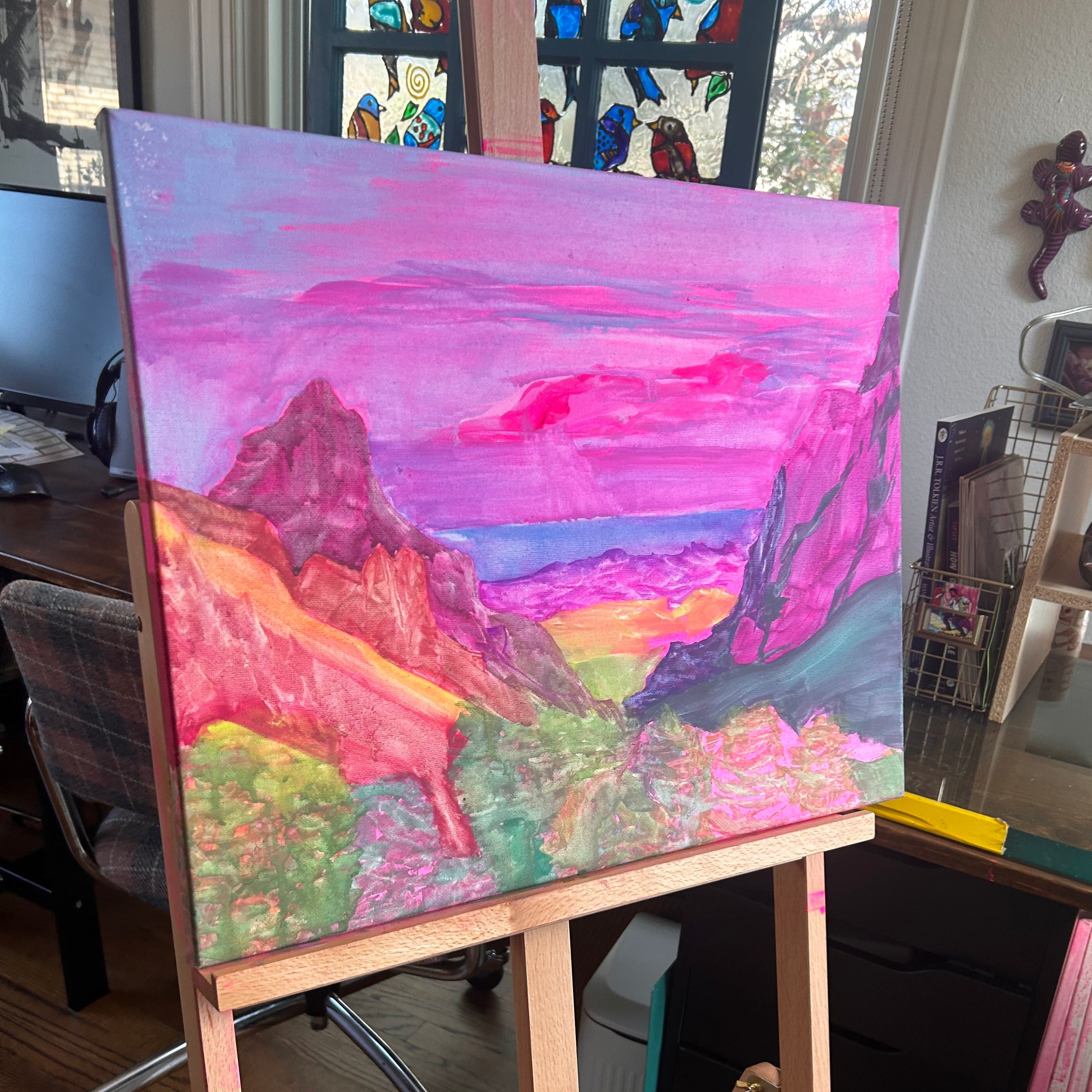 Colorful abstract painting on an easel in a studio setting